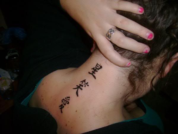 Alternative girl with japan kanji tattoo design on the back of the neck